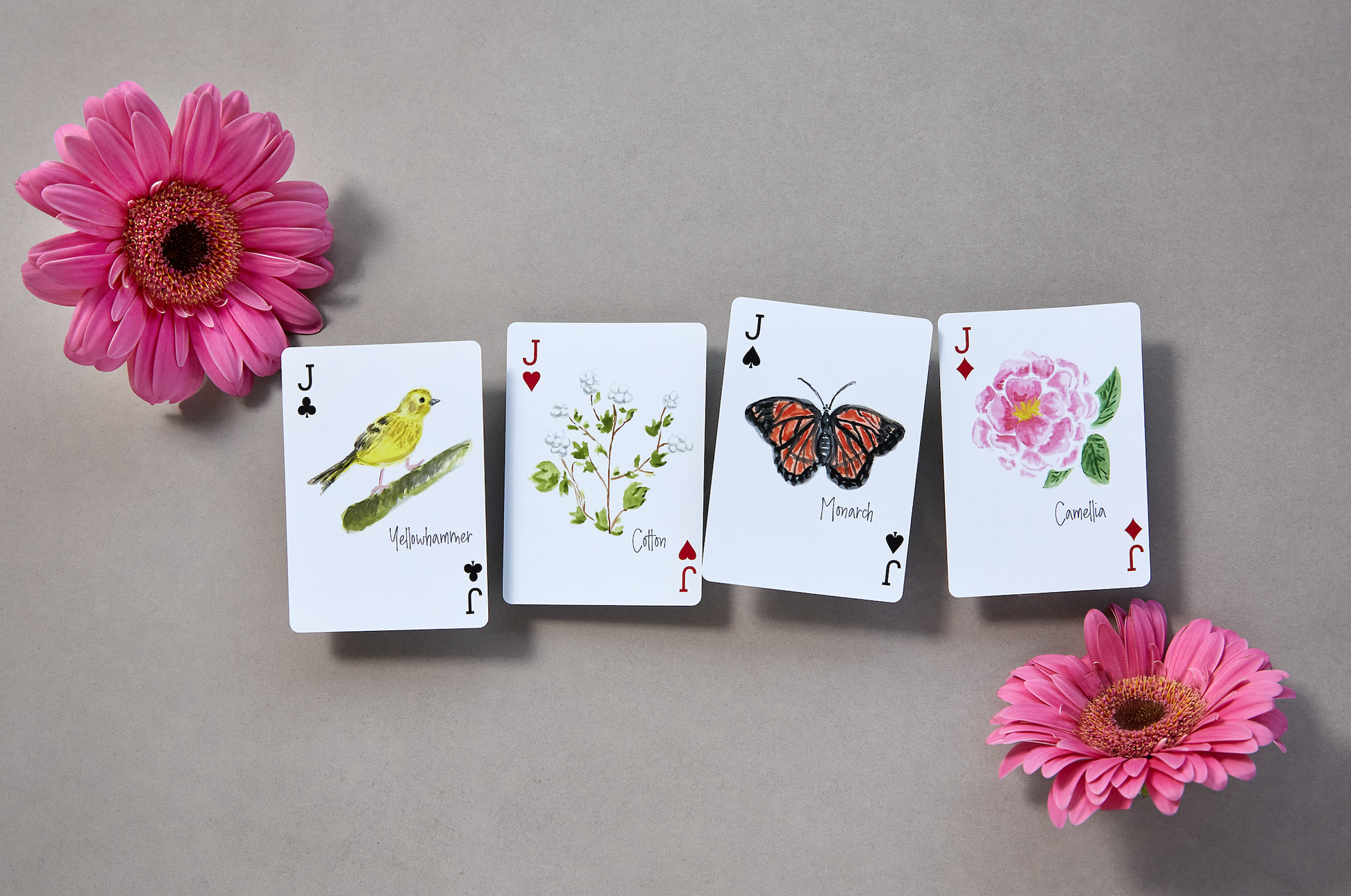 Alabama-themed playing card deck featuring watercolor illustrations of state landmarks, cities, and symbols including the USS Alabama, Yellowhammer, and cotton fields