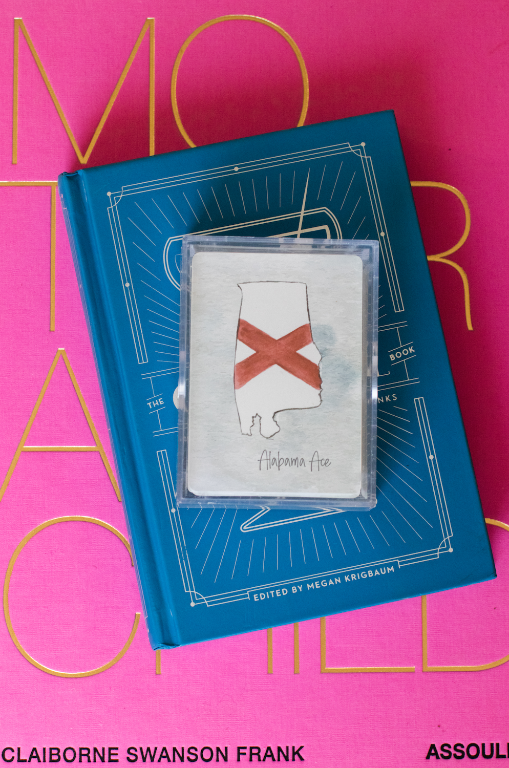 Alabama-themed playing card deck featuring watercolor illustrations of state landmarks, cities, and symbols including the USS Alabama, Yellowhammer, and cotton fields