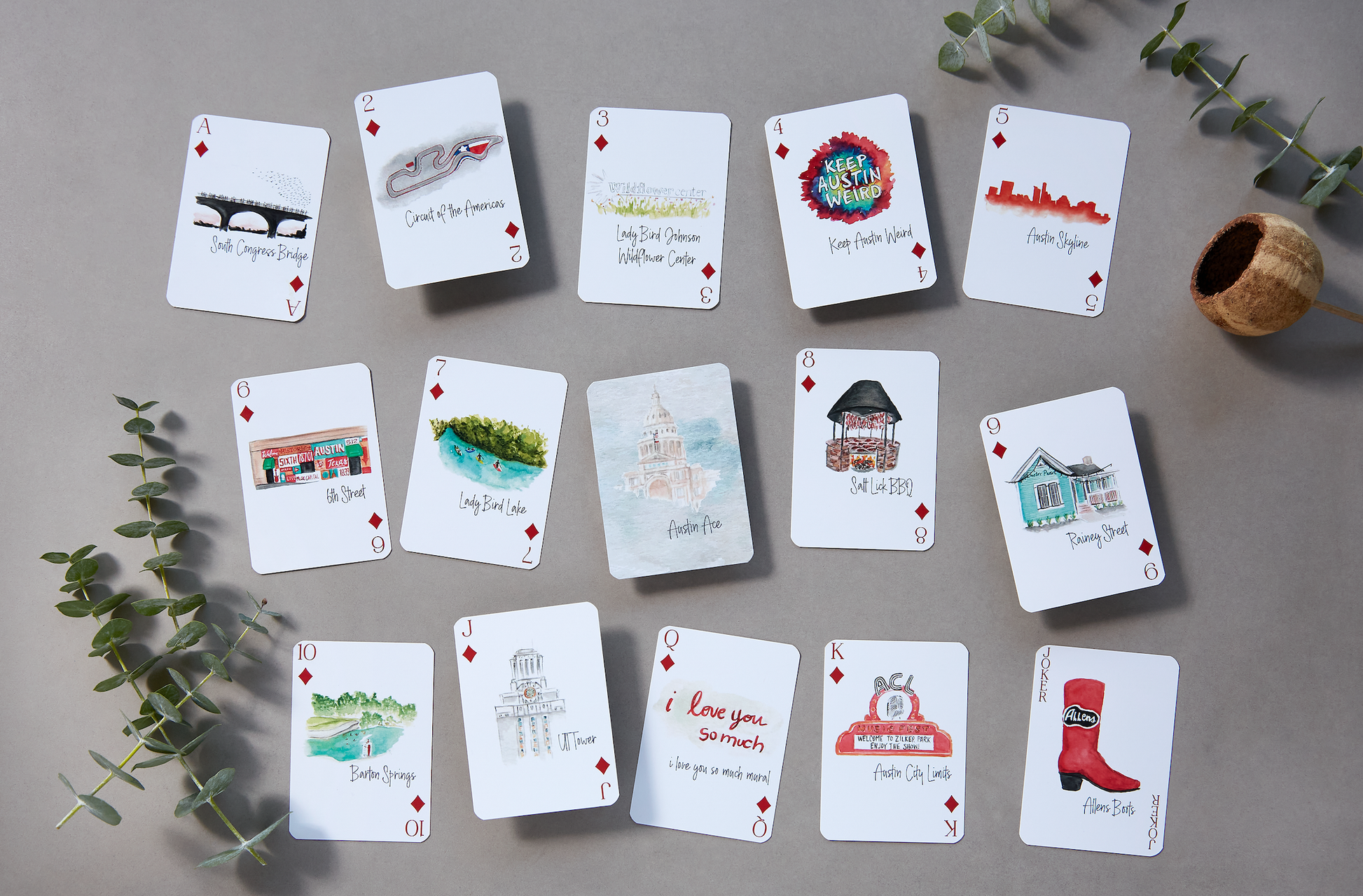 Austin-themed playing card deck featuring watercolor illustrations of city landmarks and culture including South Congress Bridge, Barton Springs, and Keep Austin Weird