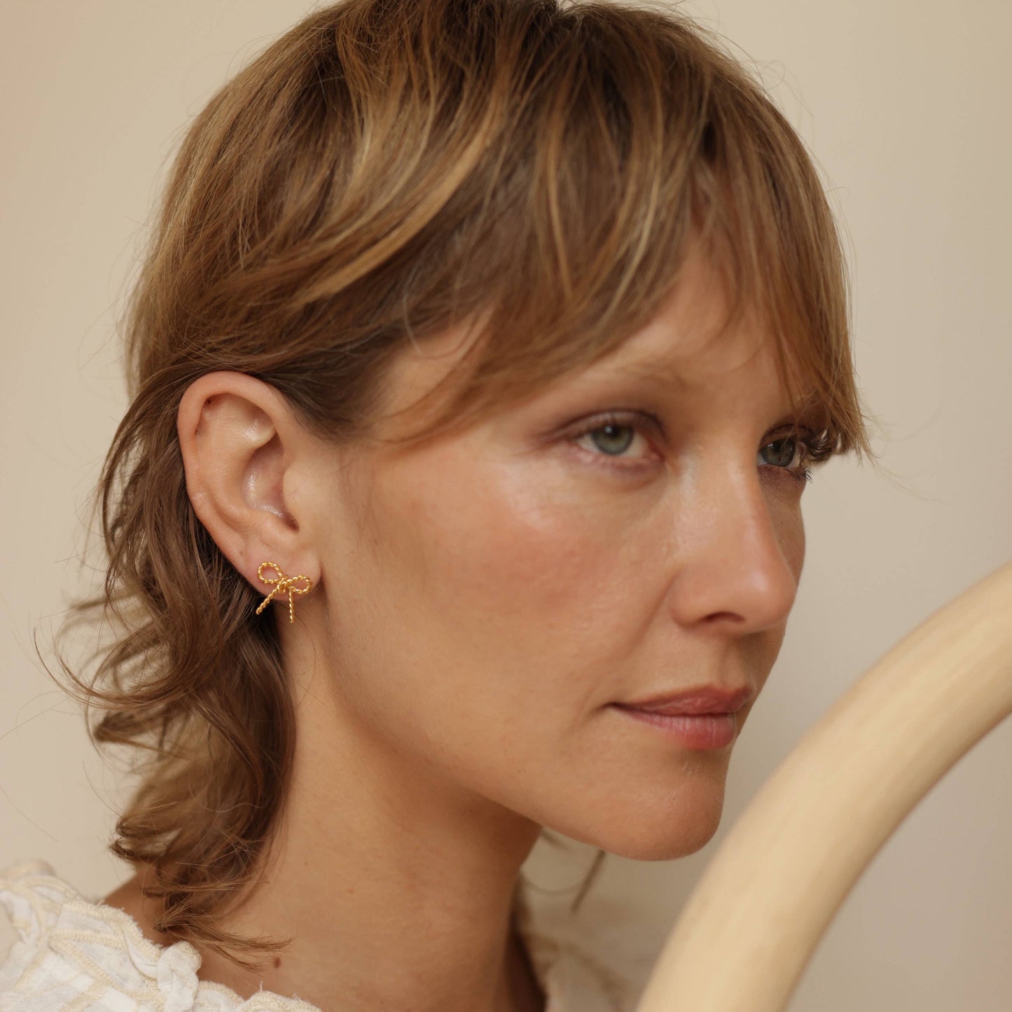 14K gold-plated bow stud earrings with twisted rope detailing and surgical steel posts